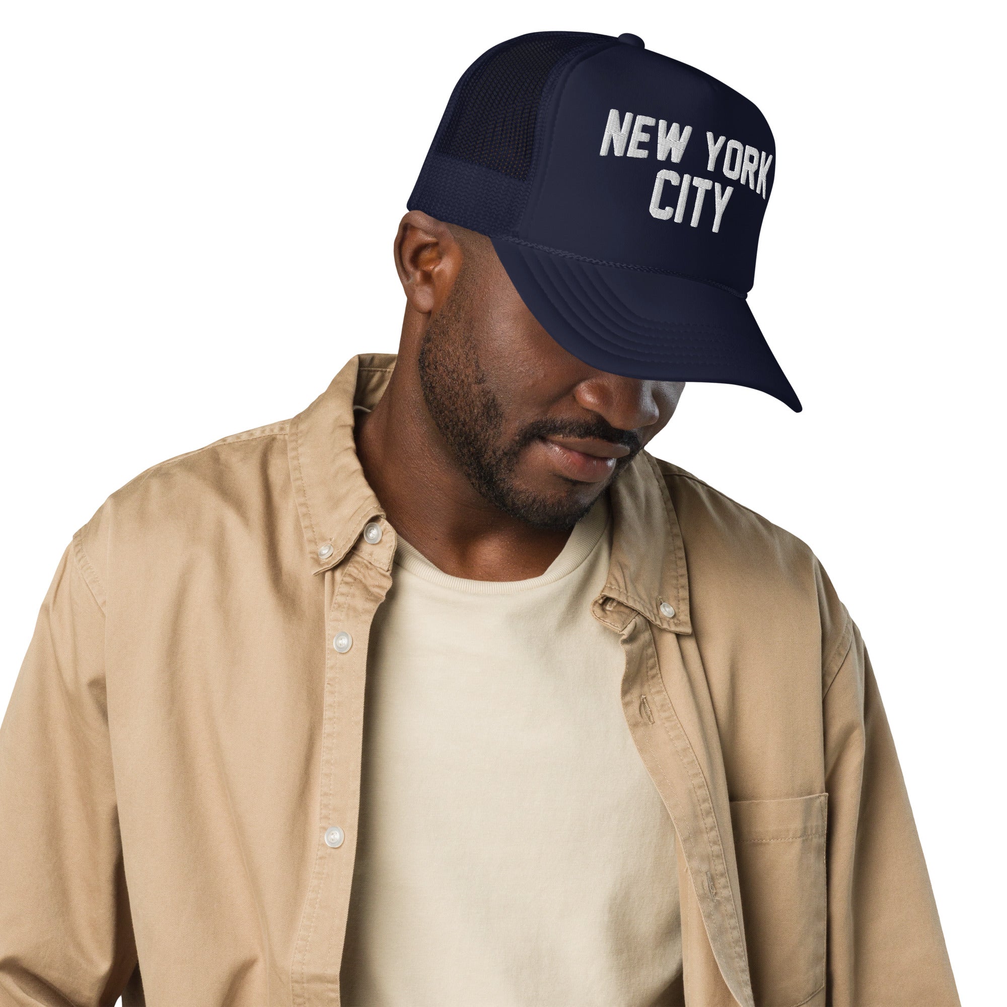 Man wearing a navy blue cap with 'New York City' text on a white background